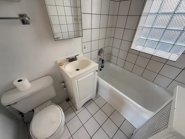 a white toilet sitting next to a bathroom sink