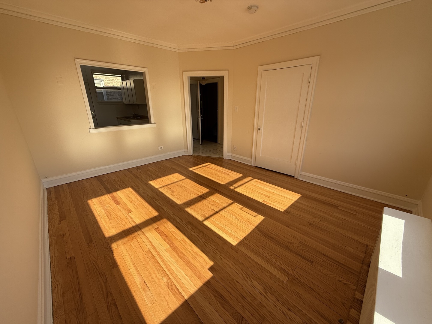 2148 Gunderson Avenue, Unit 341 Berwyn, IL 60402 - Photo 3 of 11 a view of an empty room with wooden floor and a window