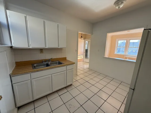 a room with a sink and cabinets