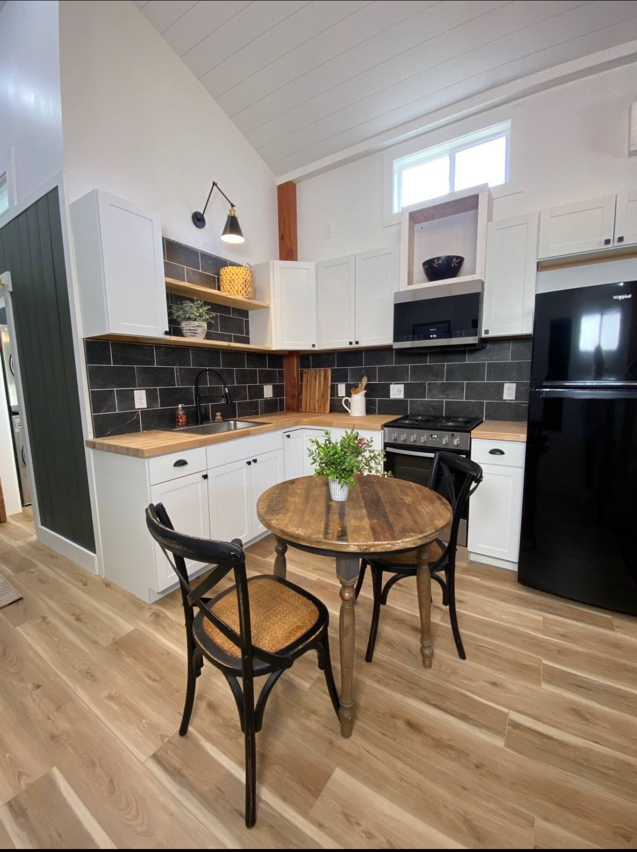 576 Rocky Valley Road Lebanon, TN 37090 - Photo 55 of 62 a kitchen with stainless steel appliances kitchen island granite countertop a table chairs microwave and sink