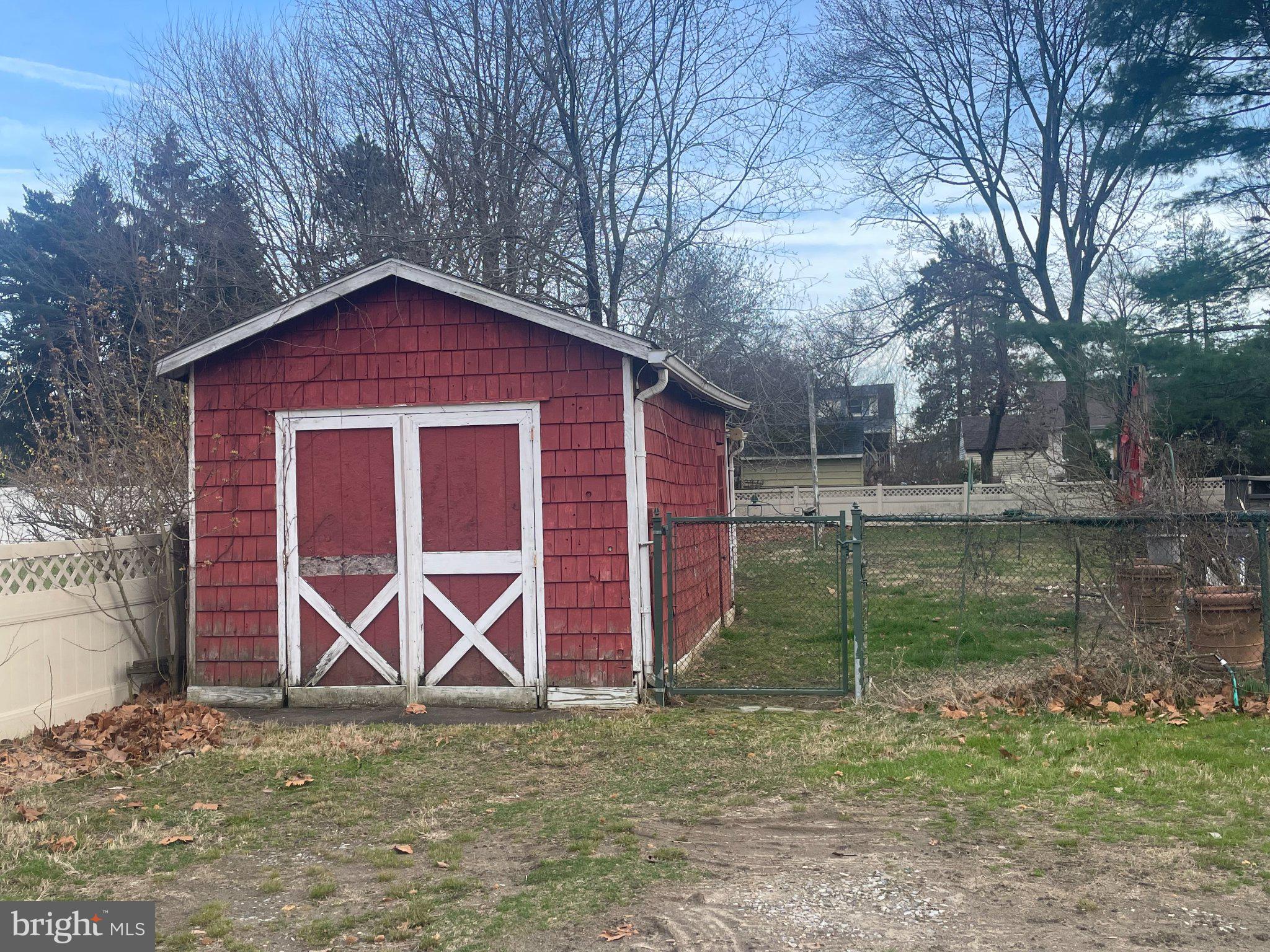 126 Thomas Avenue Maple Shade, NJ 08052 - Photo 3 of 5 Charming red shed in a tranquil yard.