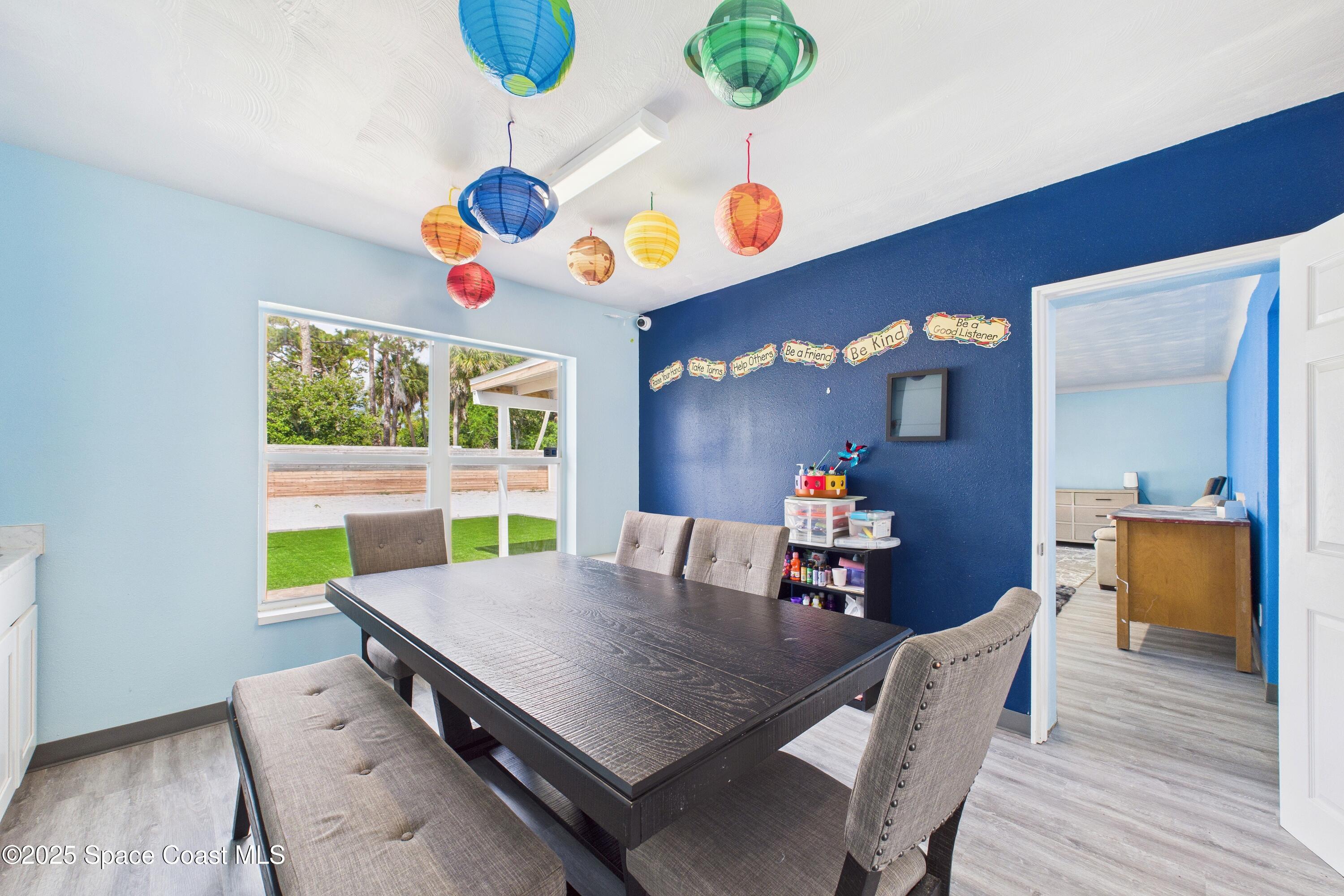 1340 South Wickham Road Melbourne, FL 32904 - Photo 18 of 50 a view of a dining room with furniture window and wooden floor