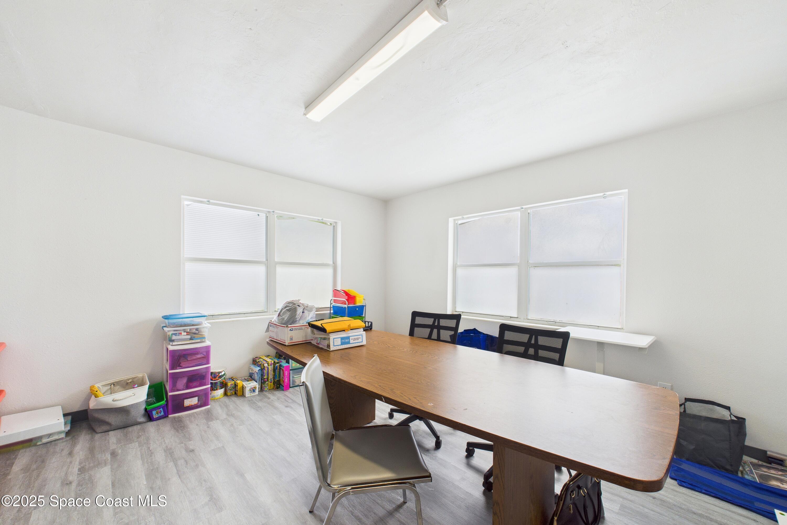 1340 South Wickham Road Melbourne, FL 32904 - Photo 22 of 50 a view of a workspace with furniture and wooden floor