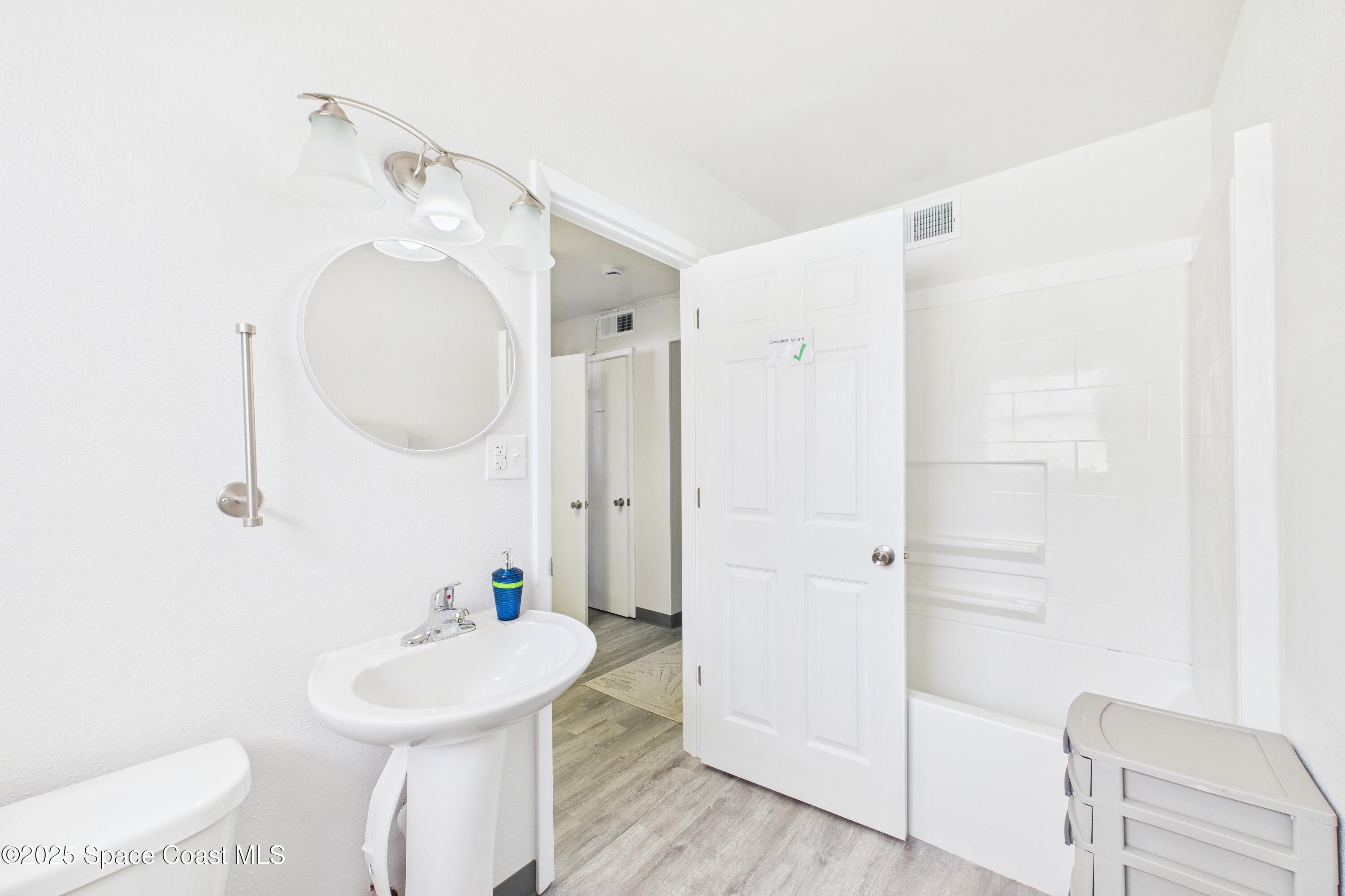 1340 South Wickham Road Melbourne, FL 32904 - Photo 28 of 50 a bathroom with a sink a toilet and shower