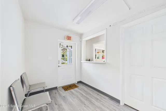 a view of room with window and wooden floor