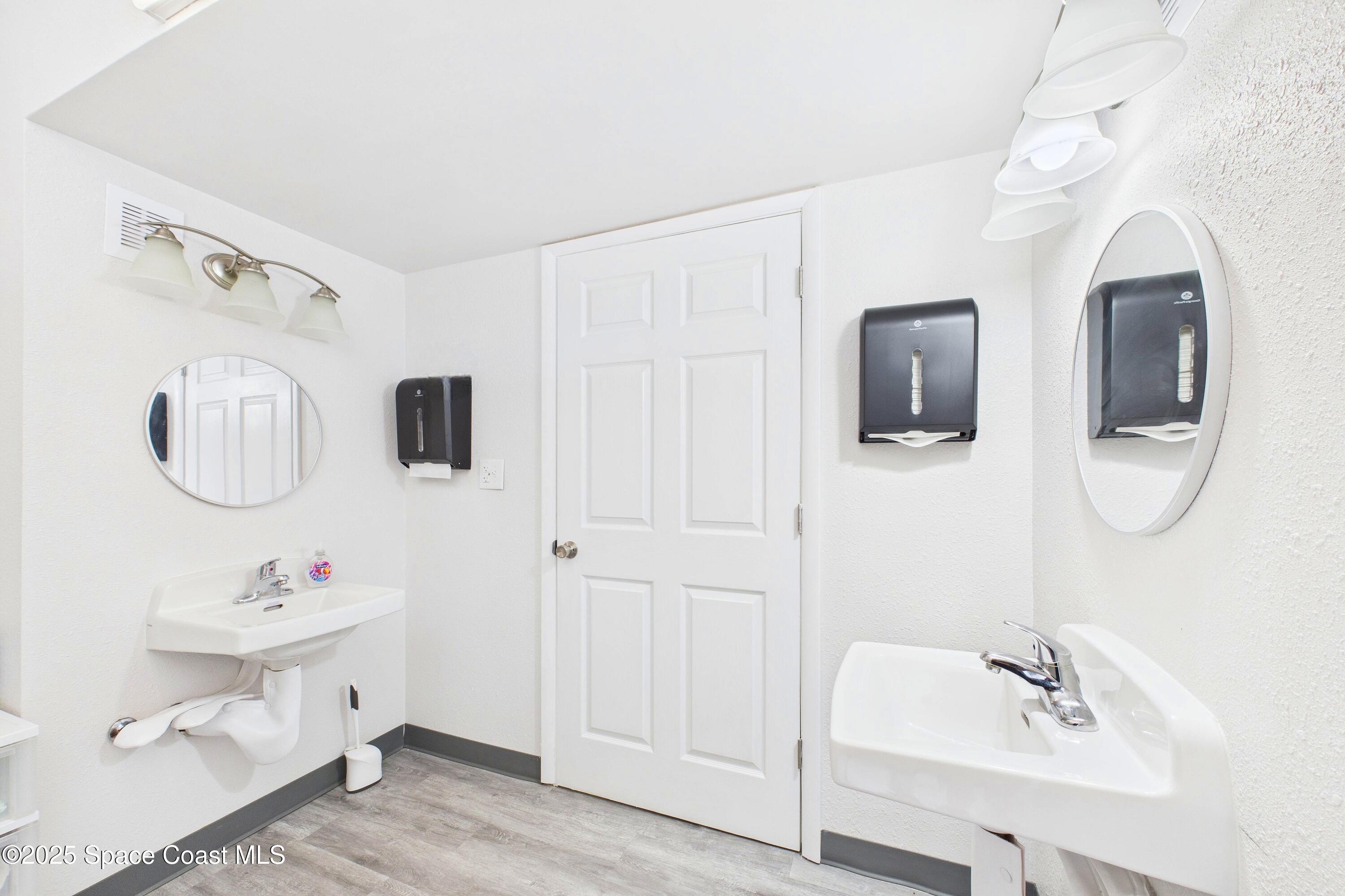 1340 South Wickham Road Melbourne, FL 32904 - Photo 37 of 50 a bathroom with a double vanity sink and mirror
