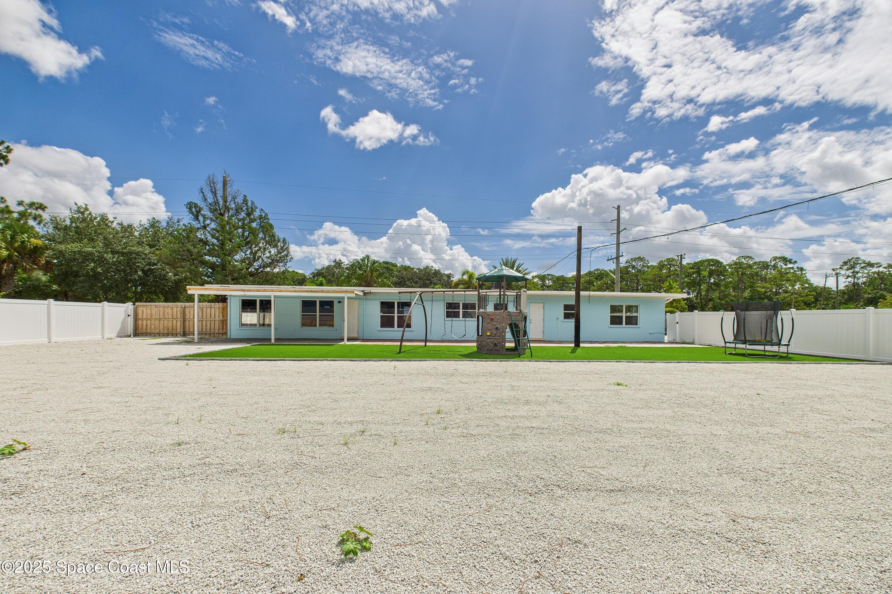 1340 South Wickham Road Melbourne, FL 32904 - Photo 43 of 50 a view of a house with a yard