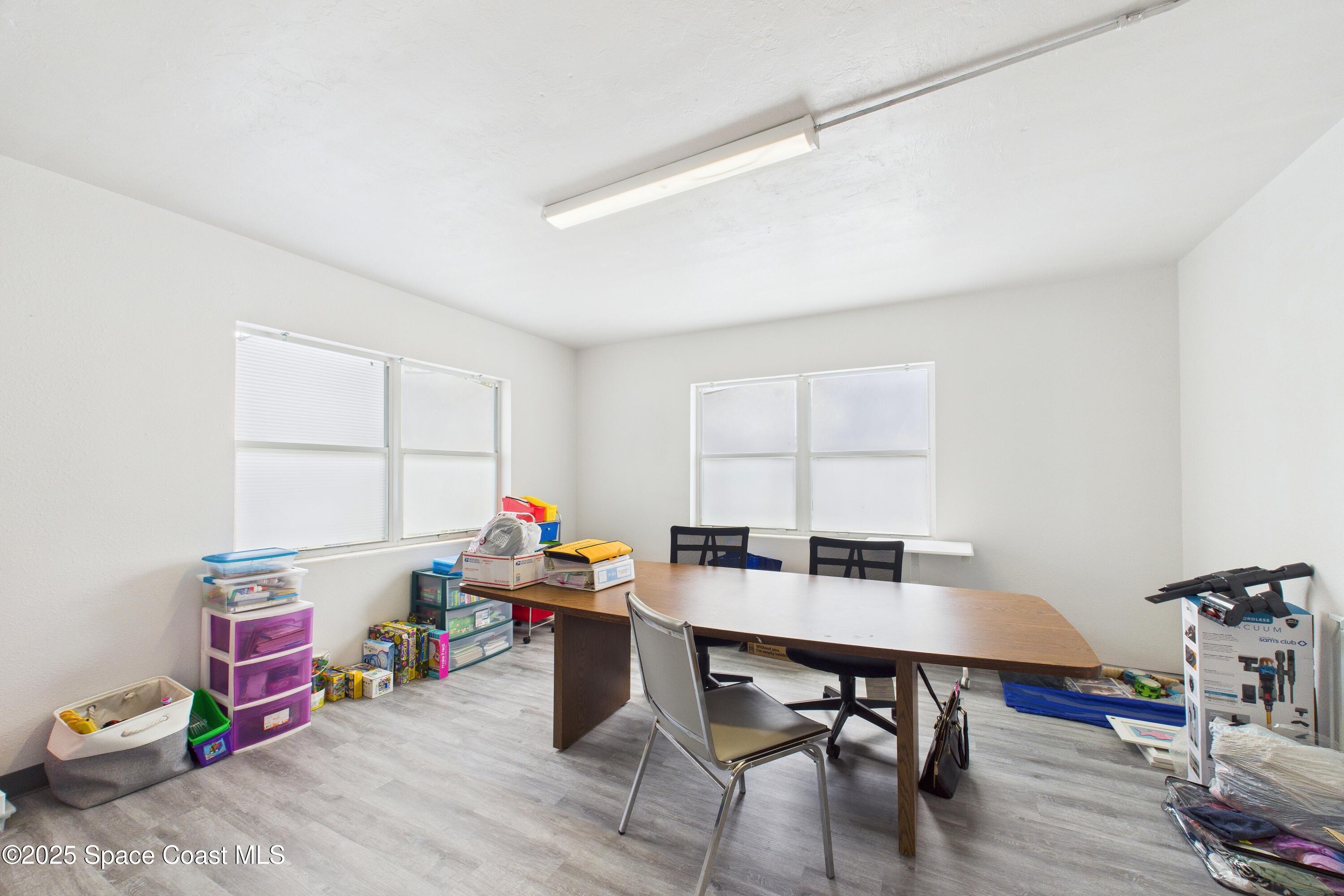 1340 South Wickham Road Melbourne, FL 32904 - Photo 44 of 50 a workspace with furniture and wooden floor