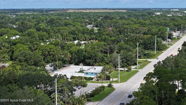 an aerial view of a house with a yard