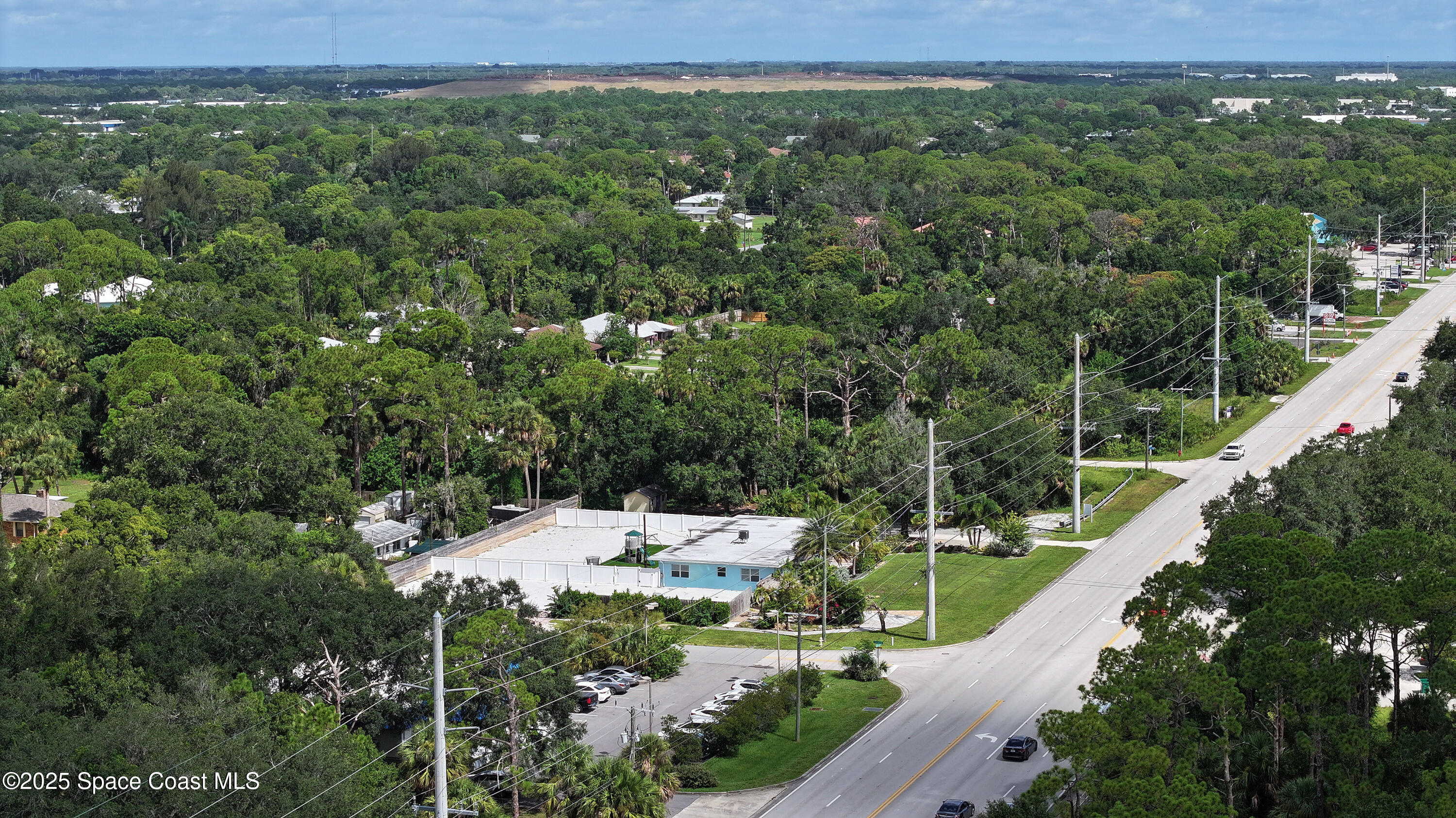 1340 South Wickham Road Melbourne, FL 32904 - Photo 46 of 50 a view of a city with lush green forest
