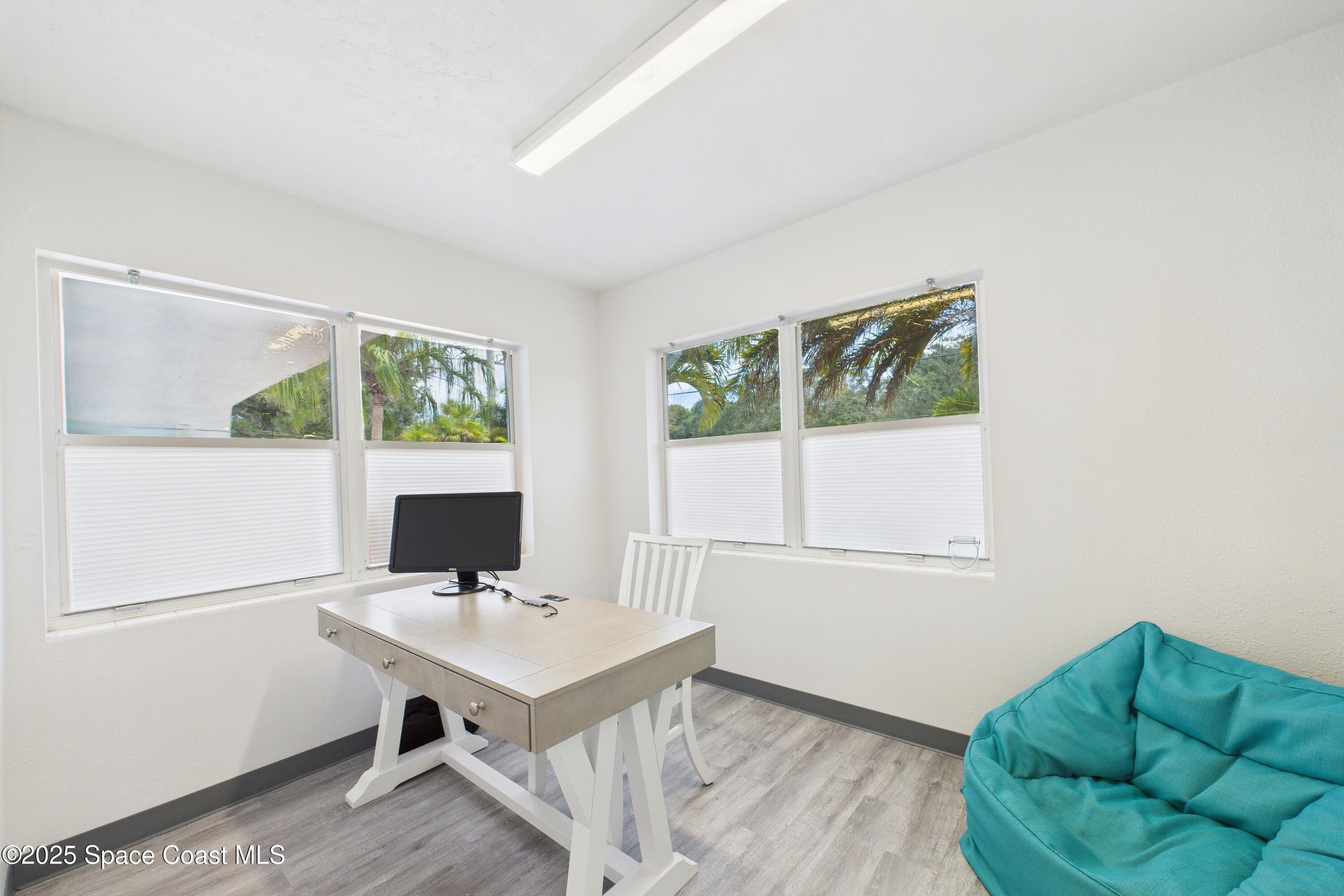 1340 South Wickham Road Melbourne, FL 32904 - Photo 48 of 50 a view of a workspace with furniture and a window