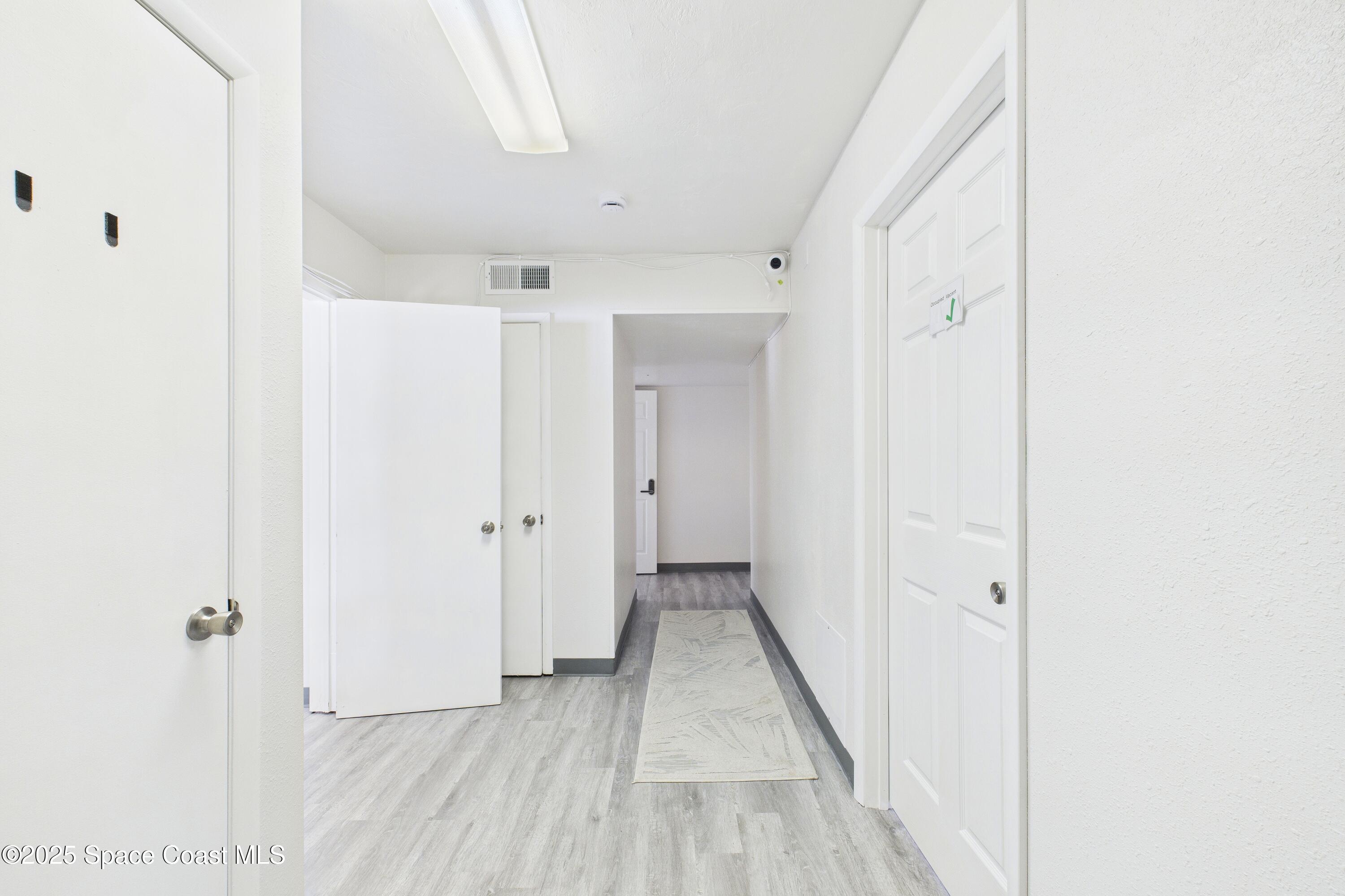 1340 South Wickham Road Melbourne, FL 32904 - Photo 5 of 50 a view of a hallway with wooden floor