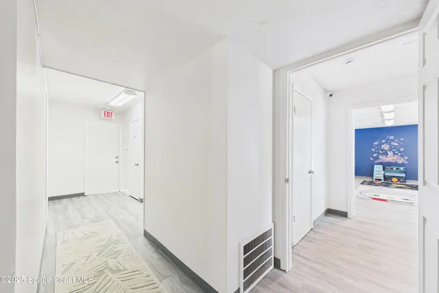 a view of hallway with wooden floor