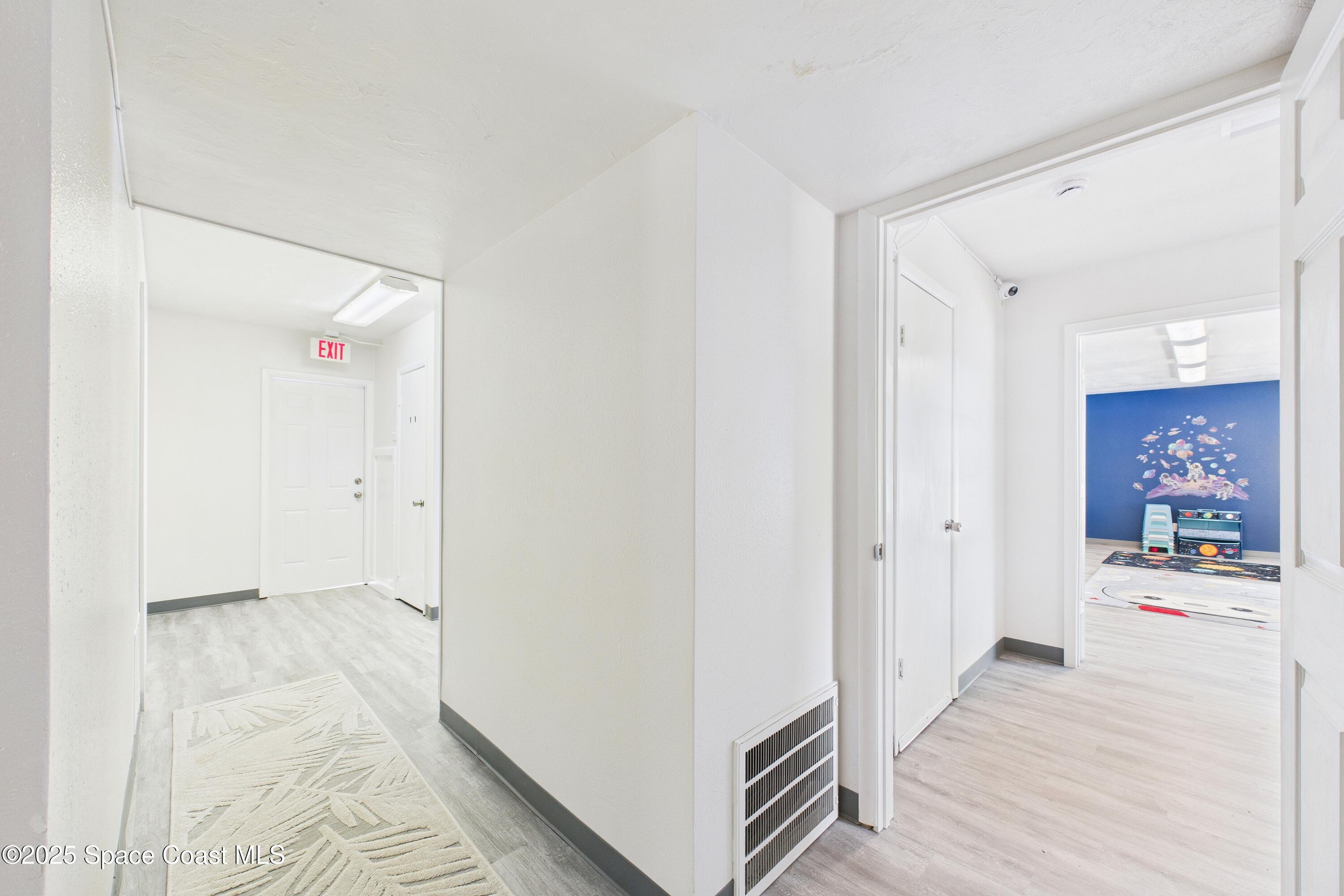 1340 South Wickham Road Melbourne, FL 32904 - Photo 9 of 50 a view of hallway with wooden floor