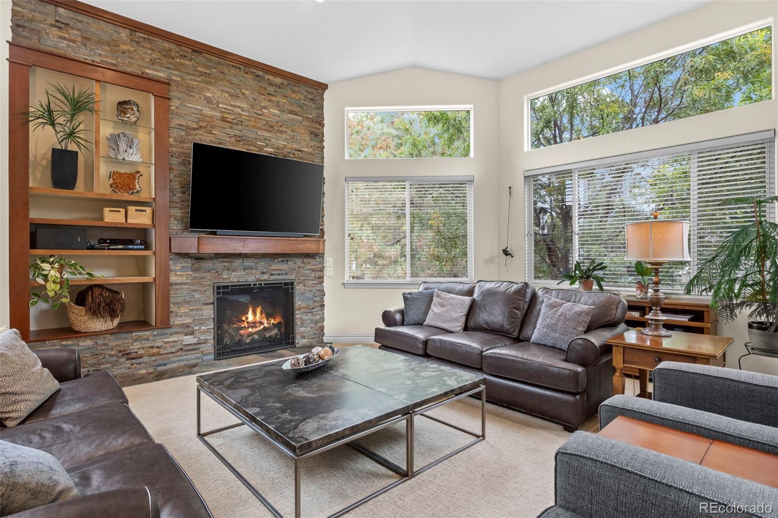 5236 Pinehurst Drive Boulder, CO 80301 - Photo 13 of 40 a living room with furniture a flat screen tv and a fireplace
