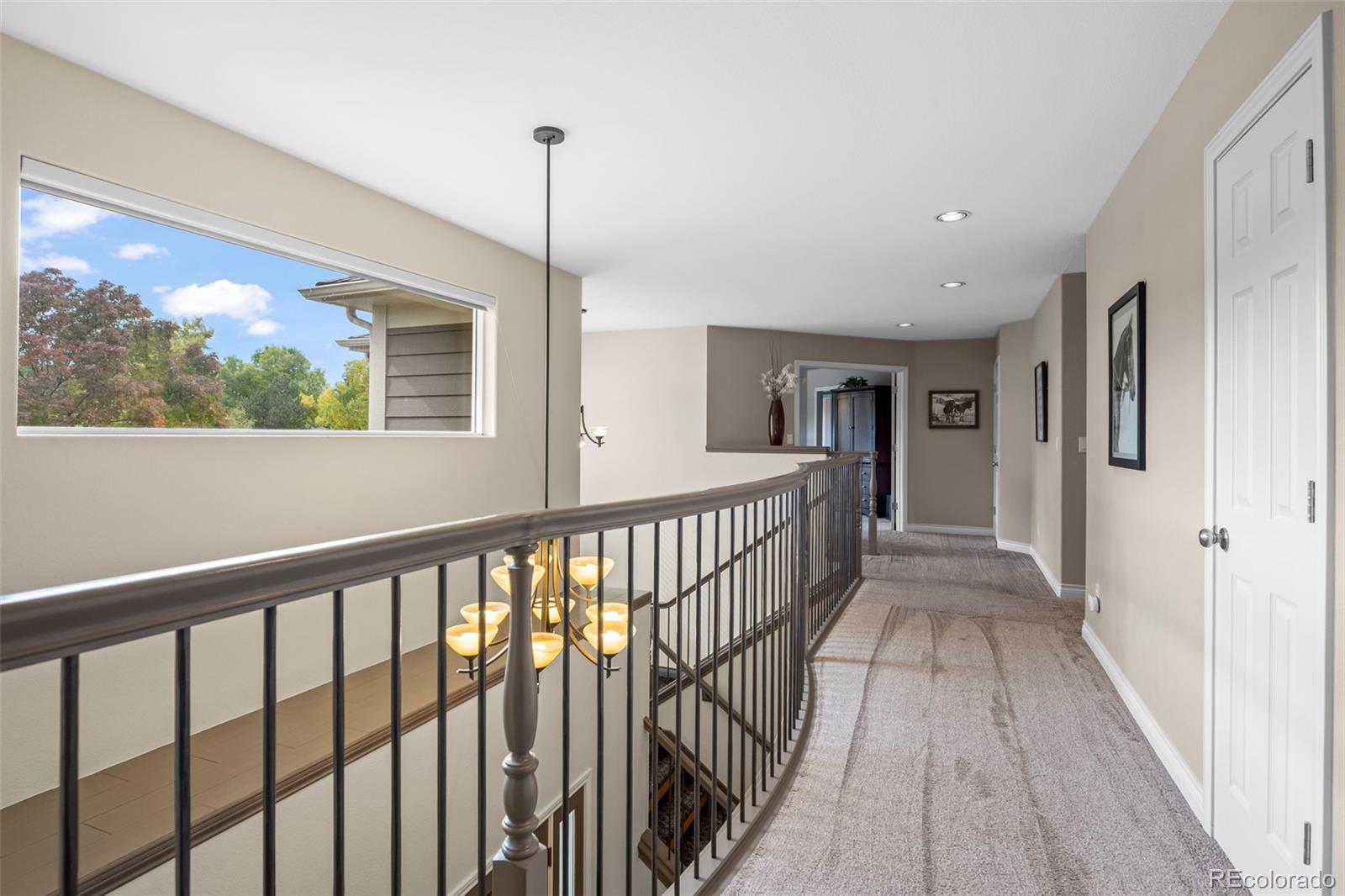 5236 Pinehurst Drive Boulder, CO 80301 - Photo 16 of 40 a view of a hallway with wooden floor and a floor to ceiling window