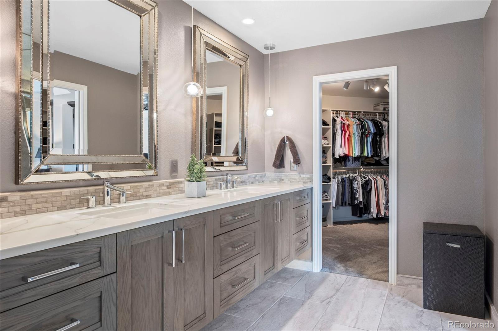 5236 Pinehurst Drive Boulder, CO 80301 - Photo 23 of 40 a en suite bathroom with a double vanity sink and a mirror