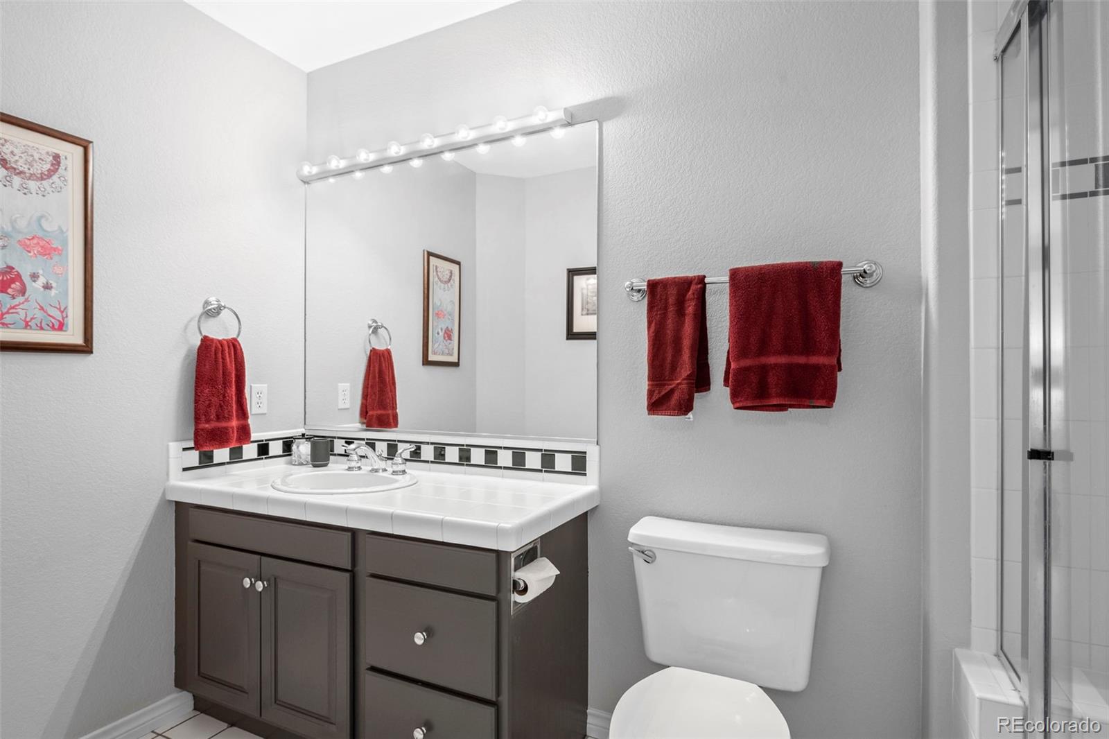 5236 Pinehurst Drive Boulder, CO 80301 - Photo 30 of 40 a bathroom with a sink vanity mirror and toilet