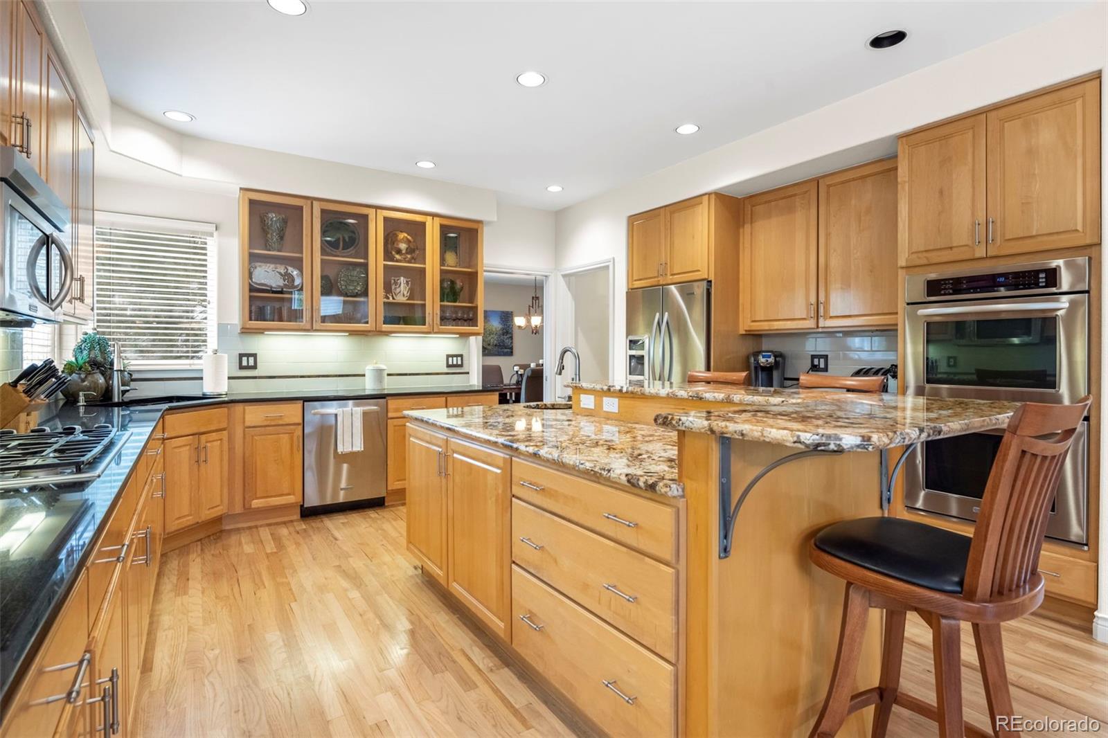 5236 Pinehurst Drive Boulder, CO 80301 - Photo 8 of 40 a large kitchen with granite countertop a stove a sink a dining table and chairs