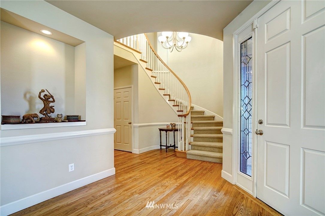 20706 37th Avenue Southeast Bothell, WA 98021 - Photo 3 of 32 a view of a hallway with wooden floor and staircase