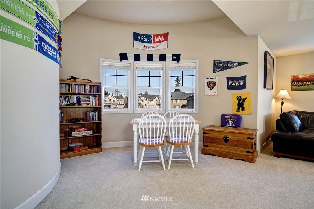20706 37th Avenue Southeast Bothell, WA 98021 - Photo 24 of 32 a bedroom with furniture and a book shelf