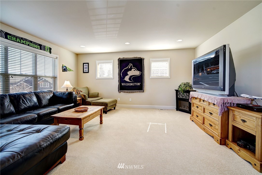 20706 37th Avenue Southeast Bothell, WA 98021 - Photo 26 of 32 a living room with furniture and a flat screen tv