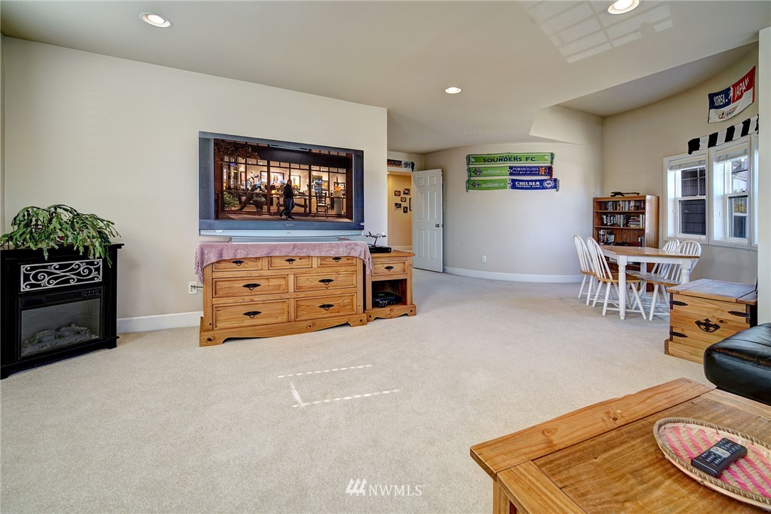20706 37th Avenue Southeast Bothell, WA 98021 - Photo 27 of 32 a living room with furniture and a wooden floor