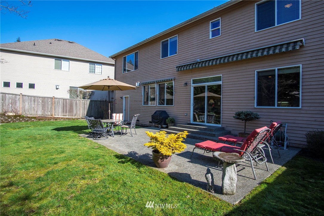 20706 37th Avenue Southeast Bothell, WA 98021 - Photo 31 of 32 a view of a house with backyard sitting area and furniture