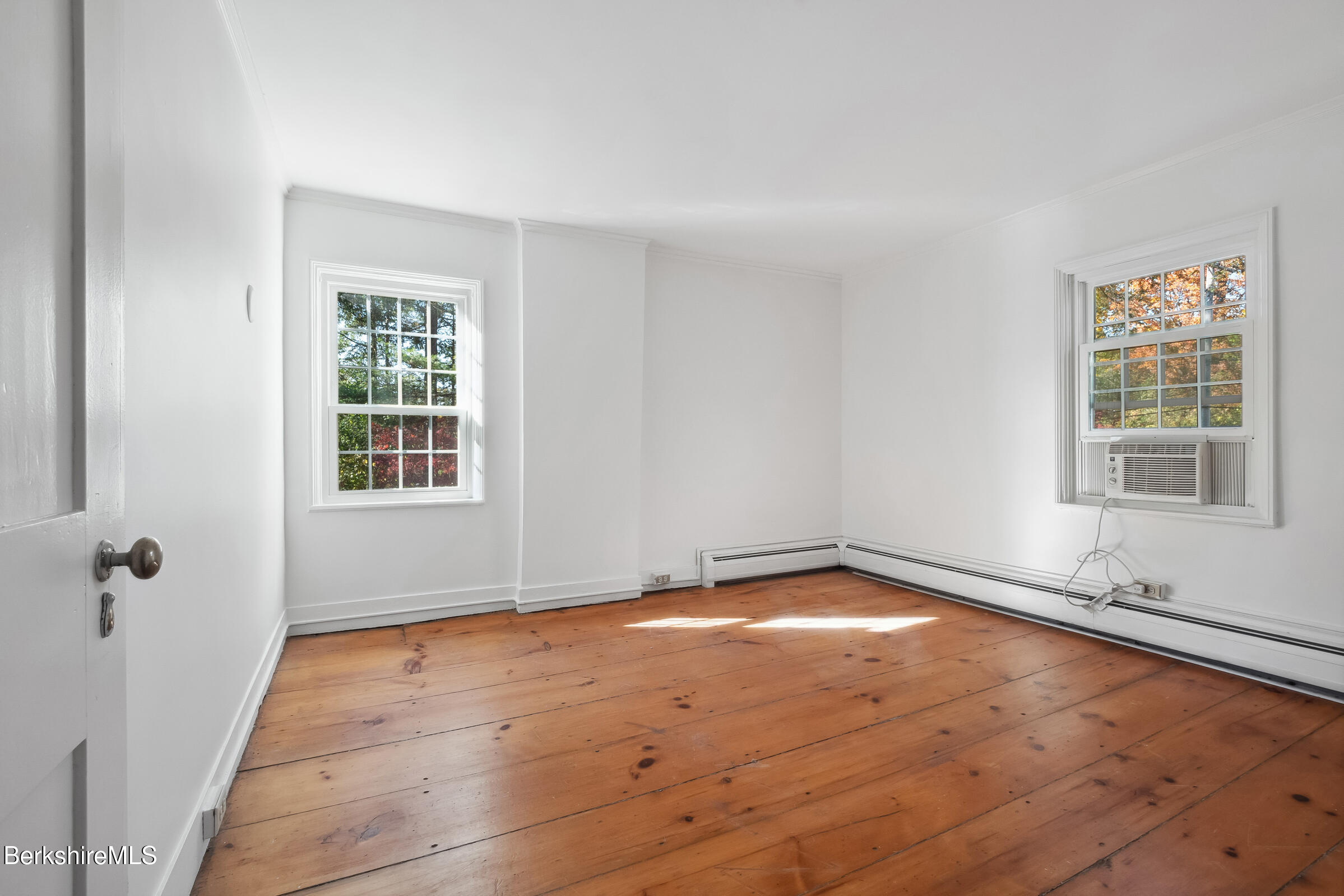 82 East Main Street Stockbridge, MA 01262 - Photo 39 of 52 an empty room with wooden floor and windows