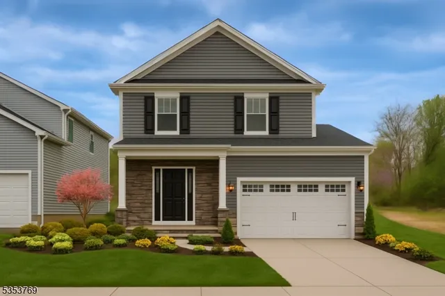 a view of a house with potted plants and a yard