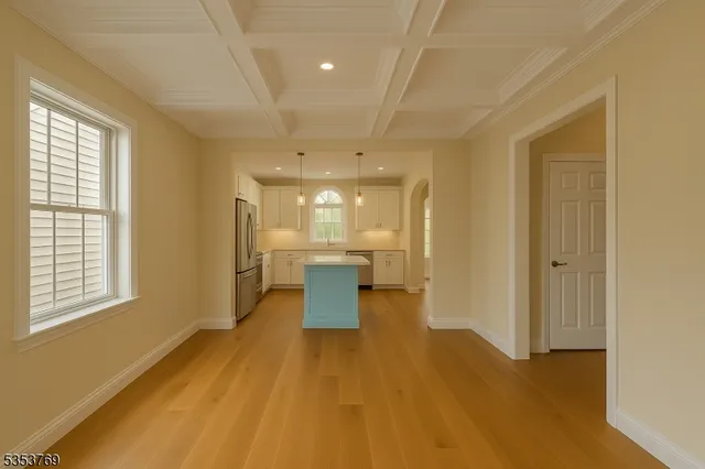 a view of a kitchen with a sink and wooden floor