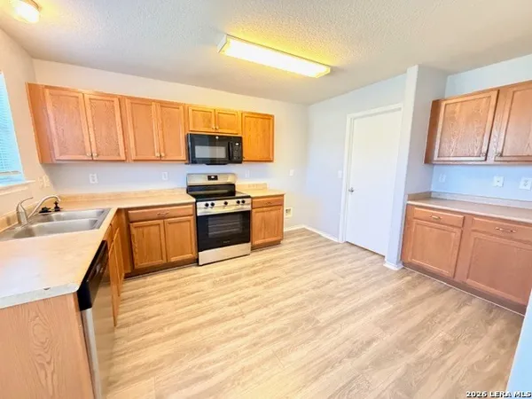a kitchen with a sink stove and cabinets