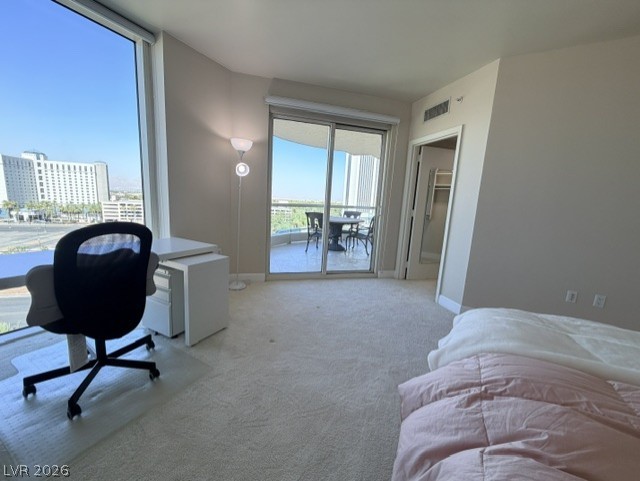 2777 Paradise Road, Unit 807 Las Vegas, NV 89109 - Photo 12 of 61 City views and direct balcony access enhance this adaptable living space.