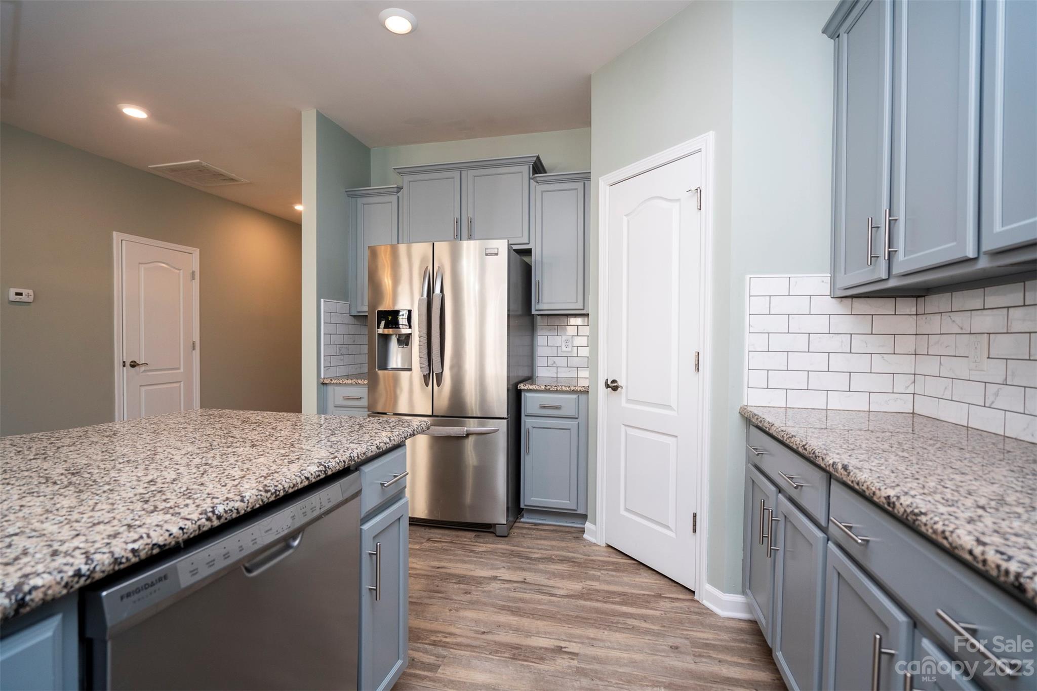 8202 Asher Chase Trail Lancaster, SC 29720 - Photo 15 of 42 a kitchen with stainless steel appliances granite countertop a sink stove and refrigerator