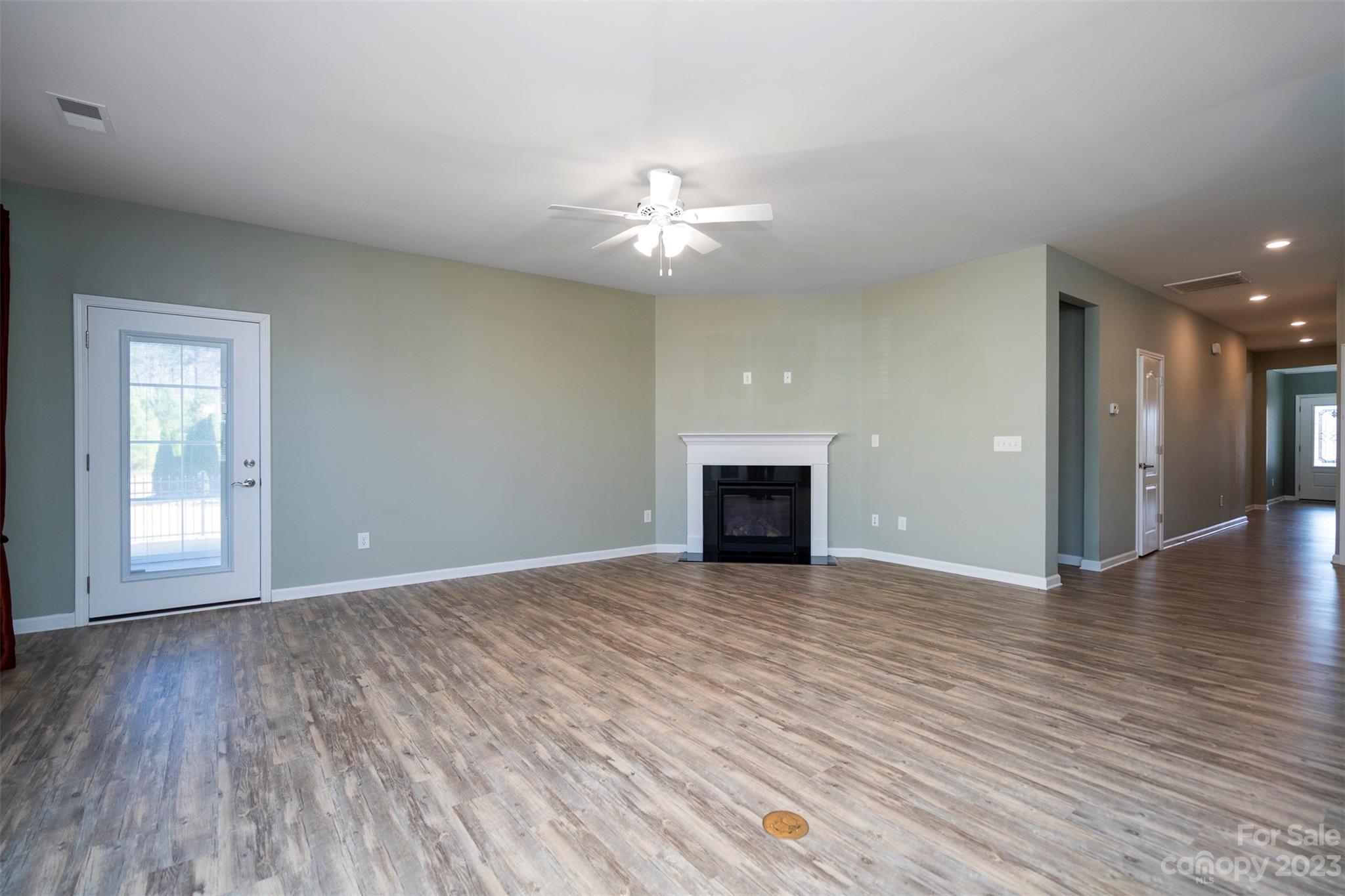 8202 Asher Chase Trail Lancaster, SC 29720 - Photo 18 of 42 a view of an empty room with wooden floor and a fireplace