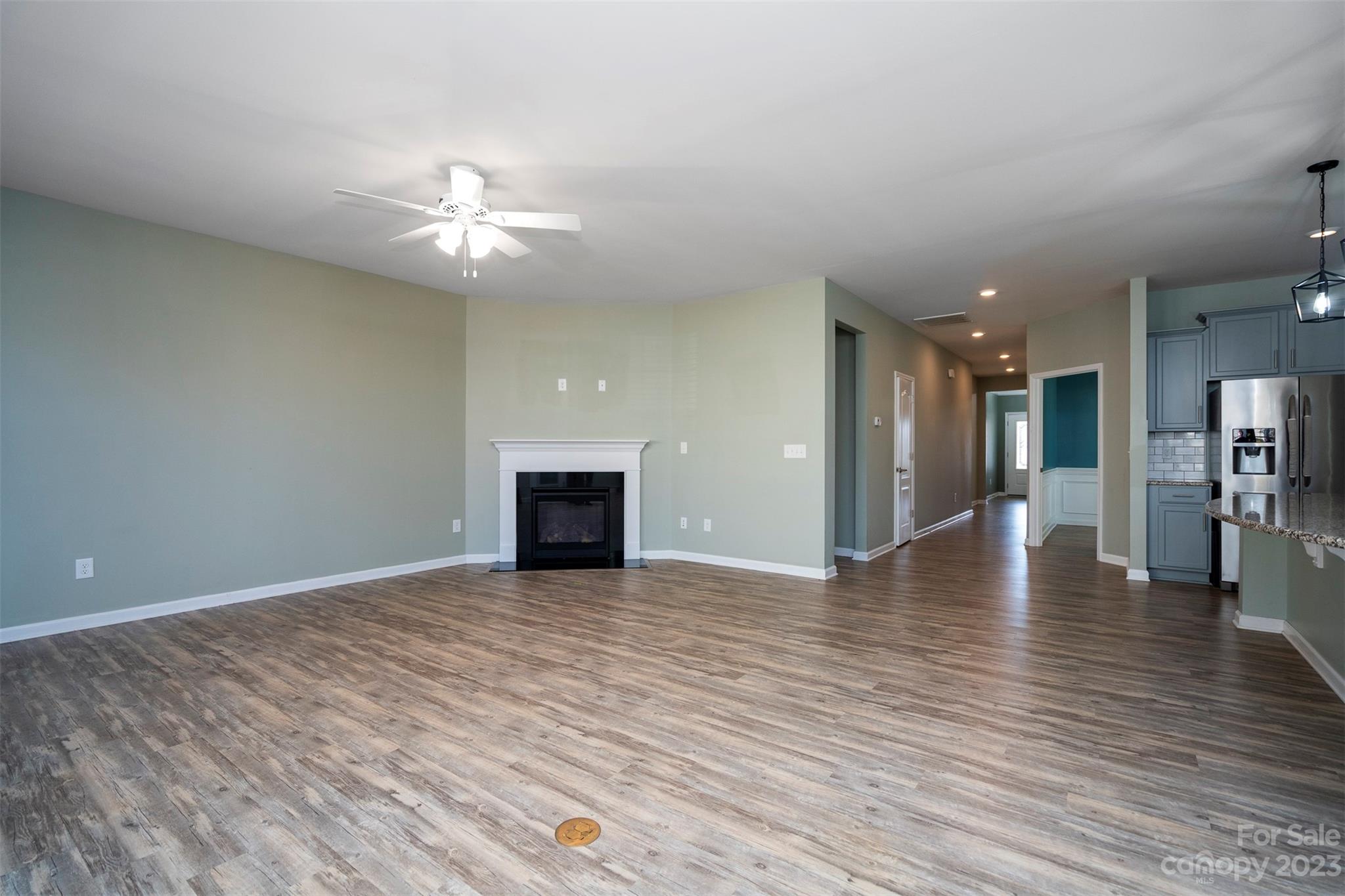 8202 Asher Chase Trail Lancaster, SC 29720 - Photo 19 of 42 wooden floor in an empty room with a kitchen
