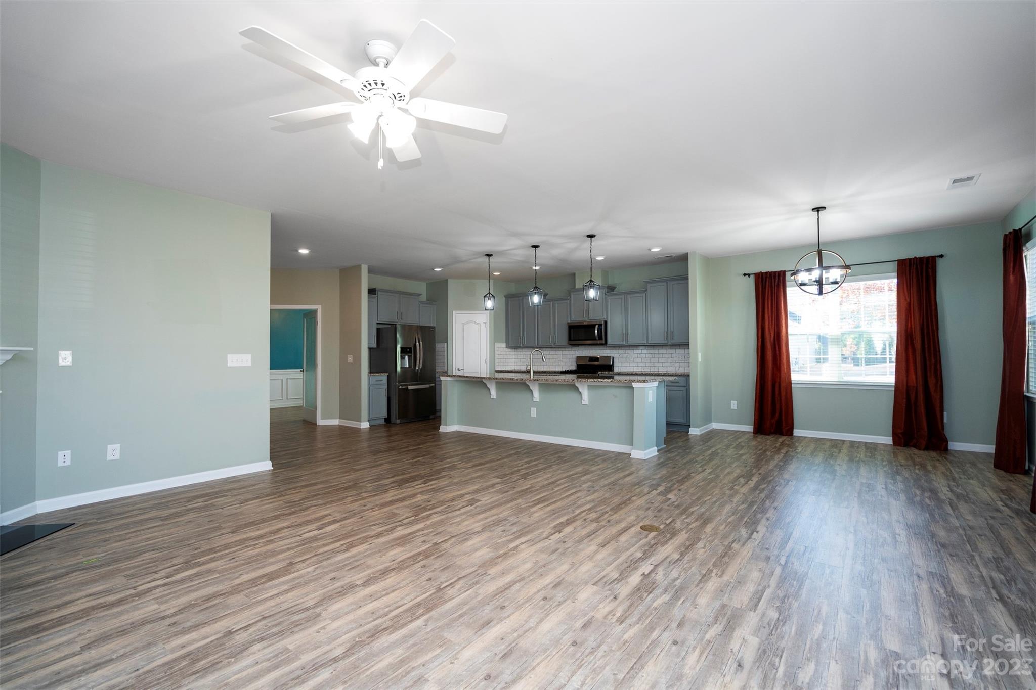 8202 Asher Chase Trail Lancaster, SC 29720 - Photo 20 of 42 an empty room with kitchen fireplace and windows
