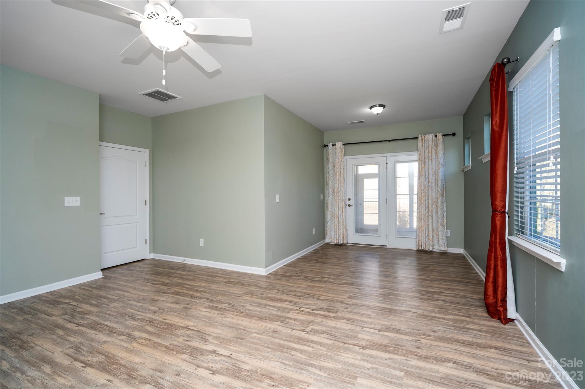 8202 Asher Chase Trail Lancaster, SC 29720 - Photo 22 of 42 a view of an empty room with a window and wooden floor