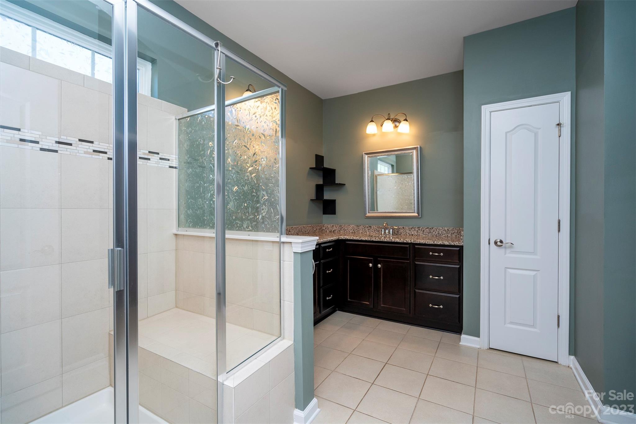 8202 Asher Chase Trail Lancaster, SC 29720 - Photo 25 of 42 a spacious bathroom with a bathtub and a double vanity sink mirror