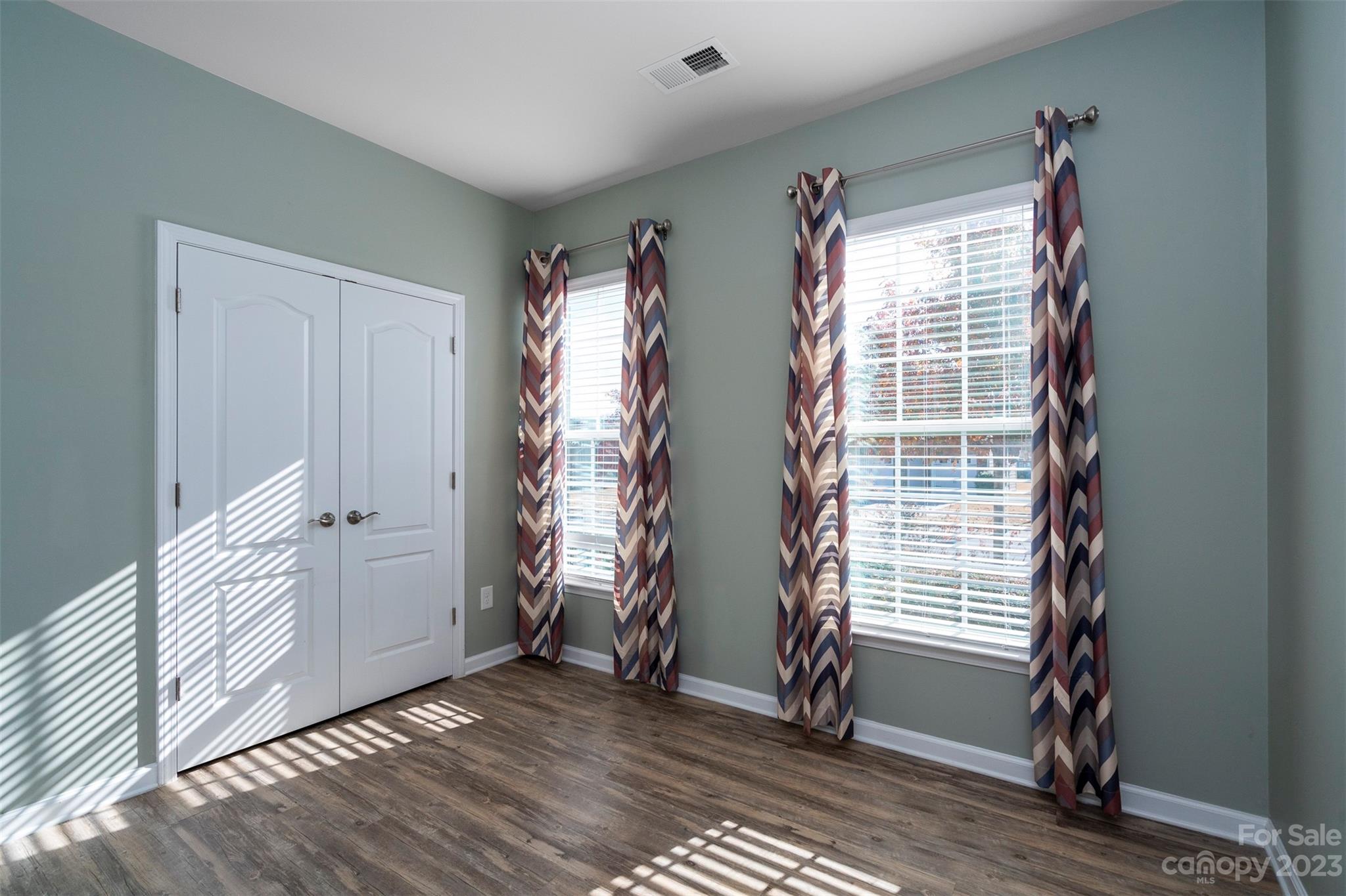 8202 Asher Chase Trail Lancaster, SC 29720 - Photo 7 of 42 an empty room with wooden floor and windows