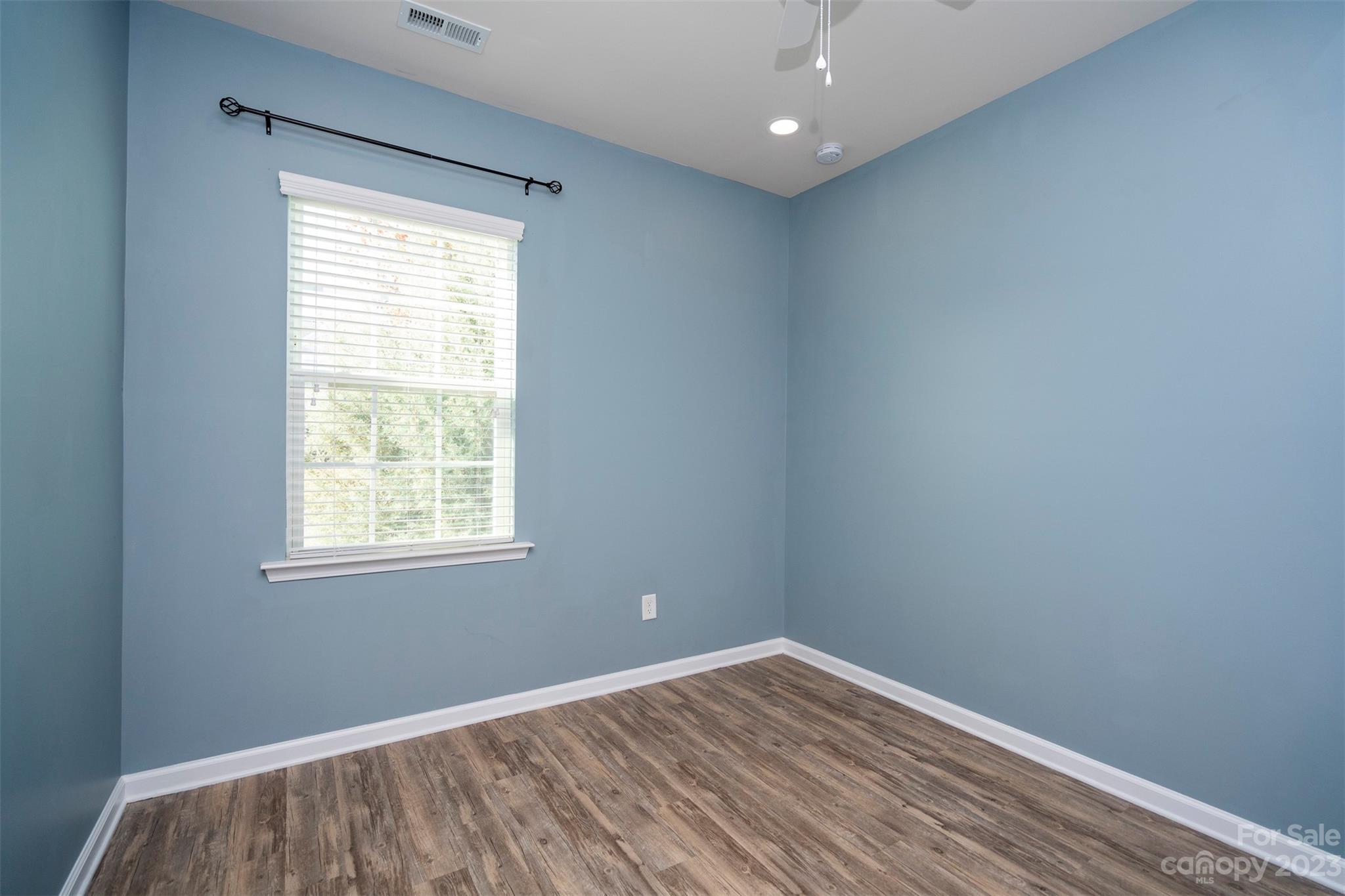 8202 Asher Chase Trail Lancaster, SC 29720 - Photo 9 of 42 an empty room with wooden floor and windows