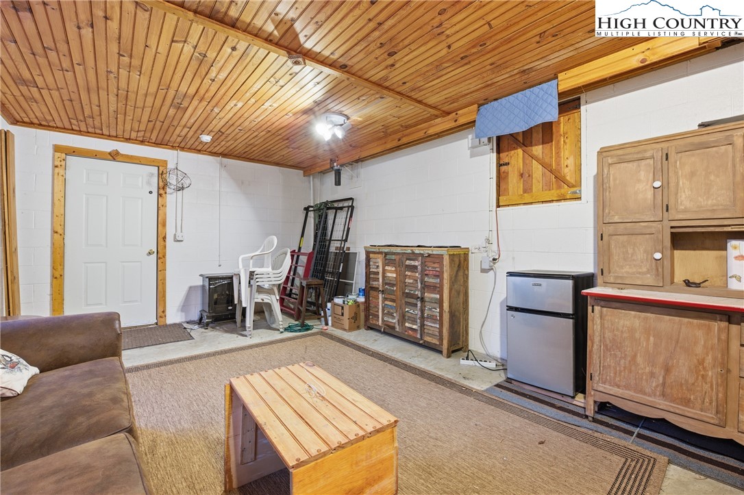 476 Moon Ridge Road Crumpler, NC 28617 - Photo 24 of 35 a living room with furniture and a wooden floor