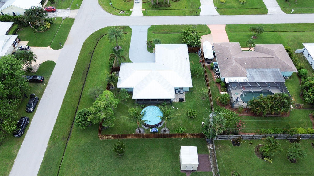 2402 Southeast Pinero Road Port St. Lucie, FL 34952 - Photo 19 of 45 an aerial view of a house with a garden and lake view
