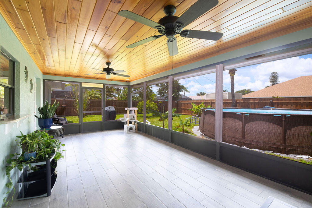 2402 Southeast Pinero Road Port St. Lucie, FL 34952 - Photo 22 of 45 a view of a porch with wooden floor and furniture