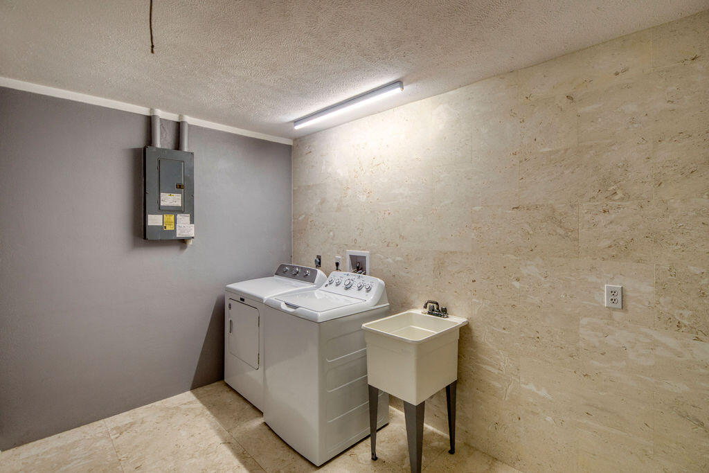 2402 Southeast Pinero Road Port St. Lucie, FL 34952 - Photo 25 of 45 a bathroom with a sink toilet and mirror