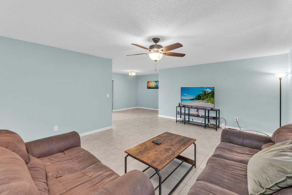 2402 Southeast Pinero Road Port St. Lucie, FL 34952 - Photo 27 of 45 a living room with furniture and a rug
