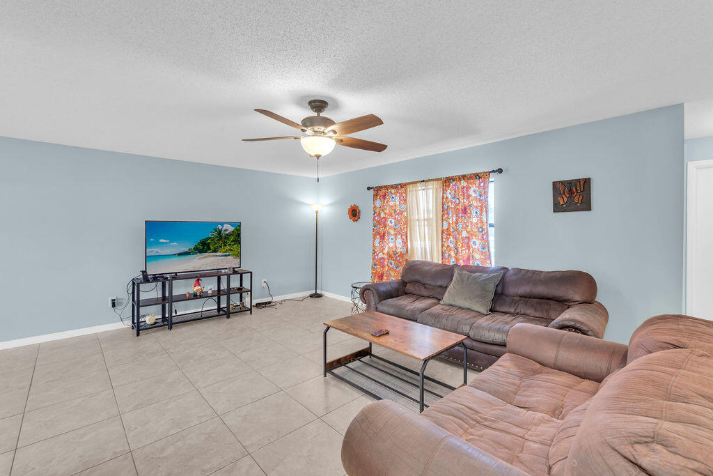 2402 Southeast Pinero Road Port St. Lucie, FL 34952 - Photo 28 of 45 a living room with furniture a couch and a window