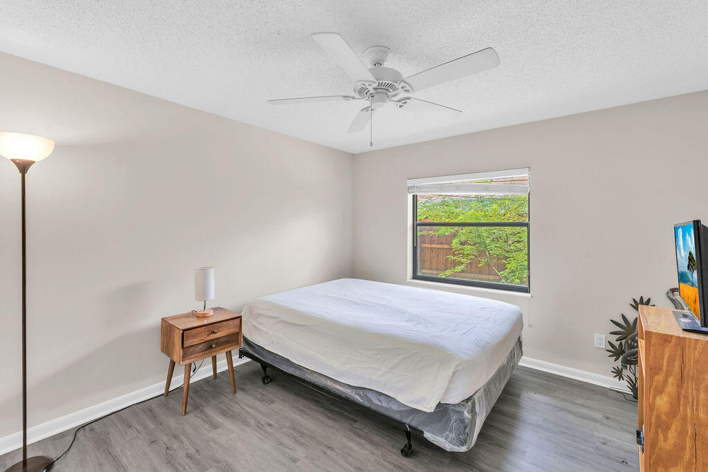 2402 Southeast Pinero Road Port St. Lucie, FL 34952 - Photo 38 of 45 a bedroom with a bed and a table in it