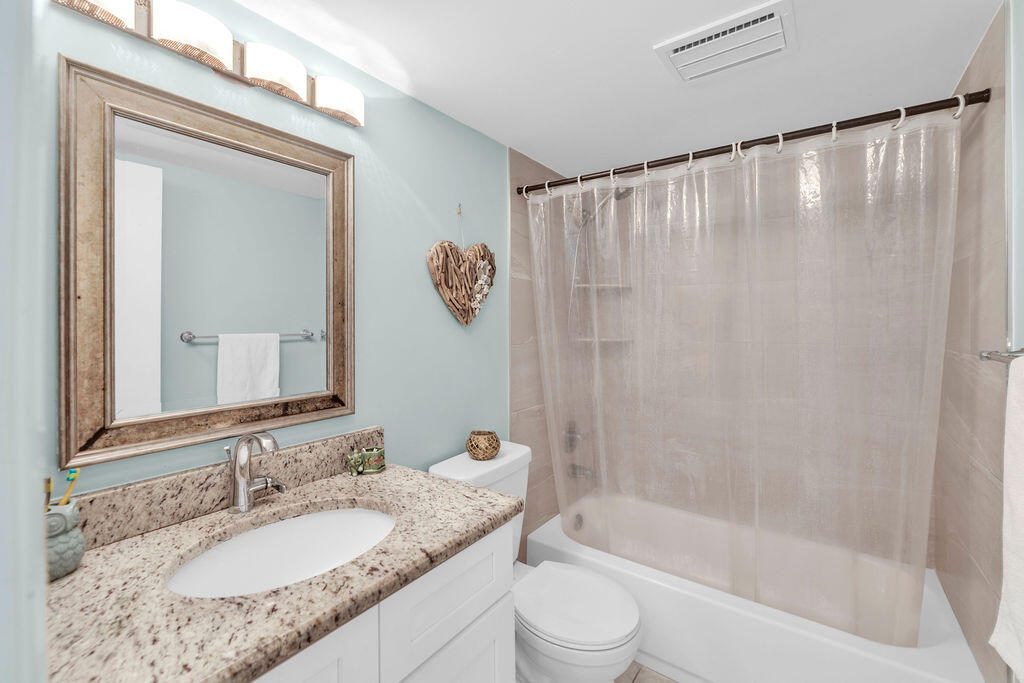 2402 Southeast Pinero Road Port St. Lucie, FL 34952 - Photo 40 of 45 a bathroom with a granite countertop sink and a mirror