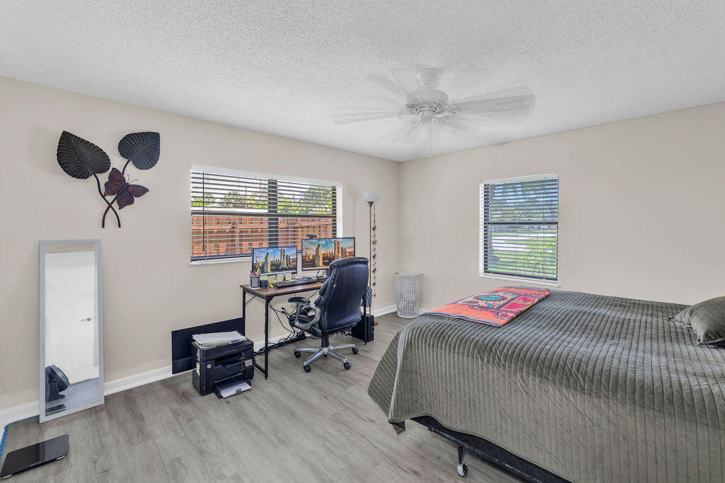 2402 Southeast Pinero Road Port St. Lucie, FL 34952 - Photo 41 of 45 a bedroom with a bed and a window